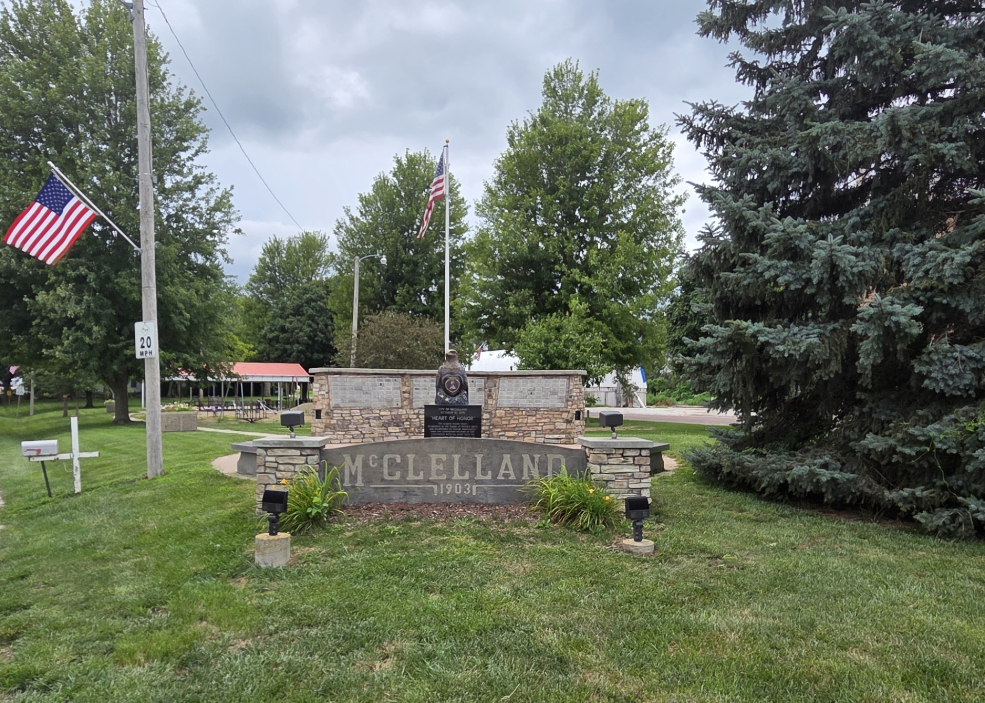 McClelland sign in front of the town's Eagle of Honor statue.