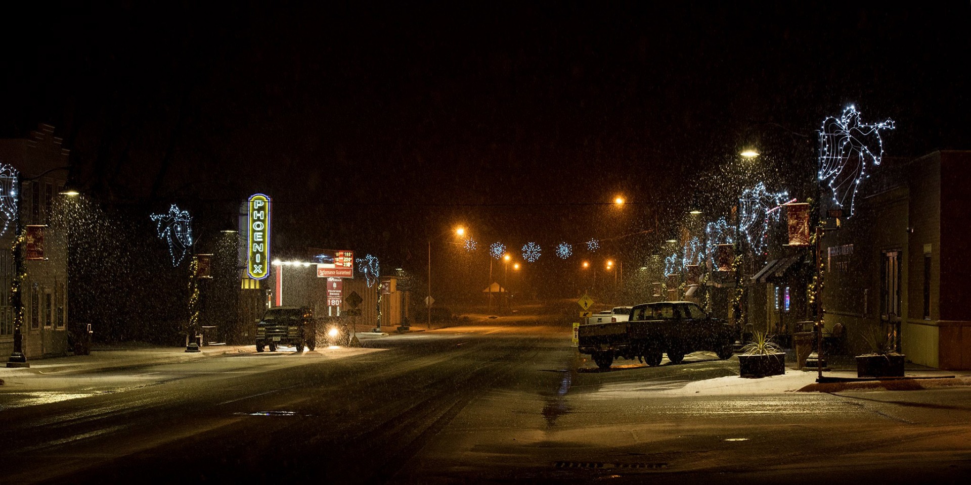 Downtown Neola and the Phoenix Movie Theater at night, lit up with holiday lights.