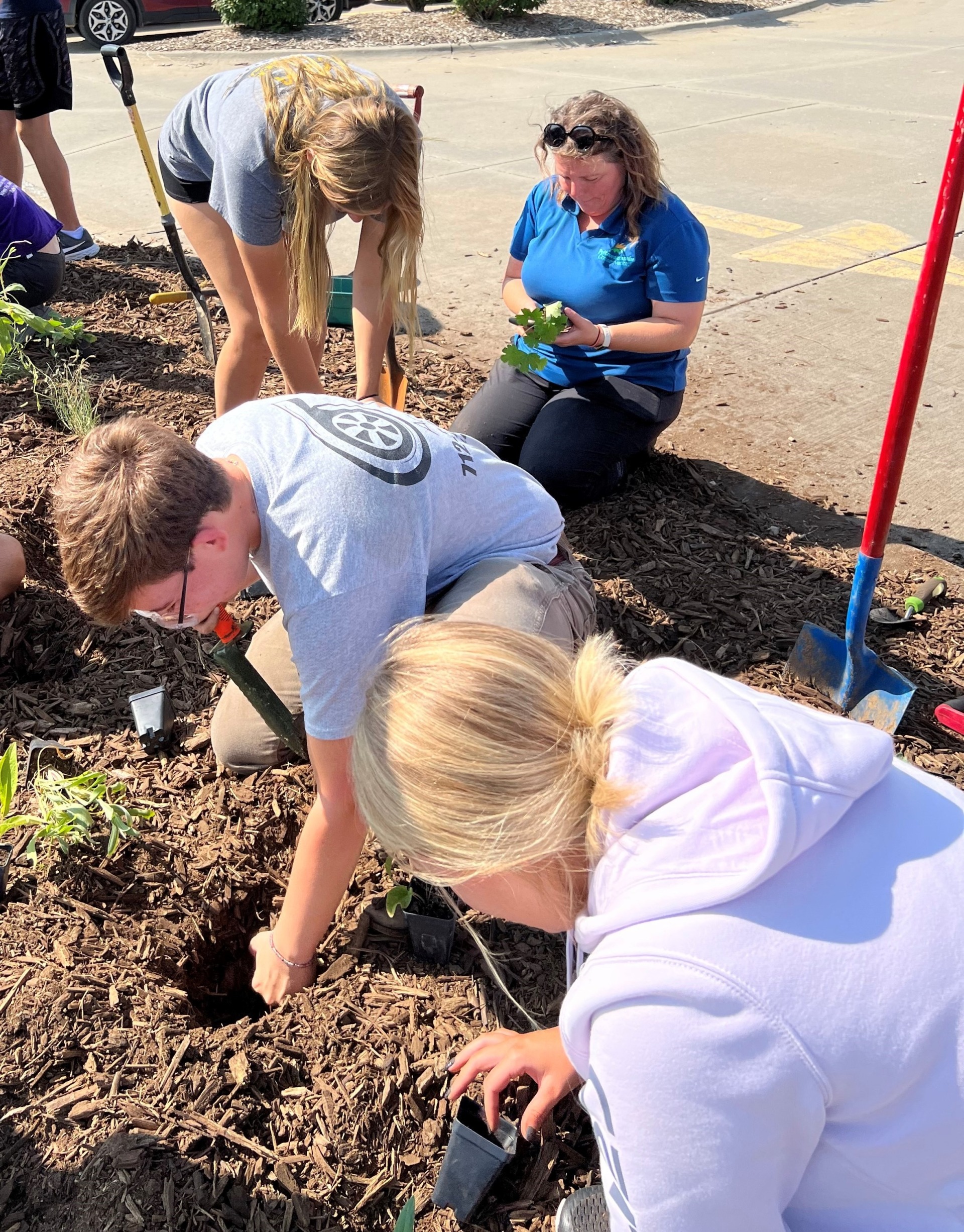 Tri-Center High School students plant native plant plugs on school grounds, May 2022.