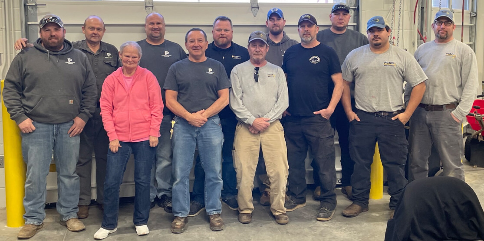 Pottawattamie County Building and Grounds staff members standing together in their work area.