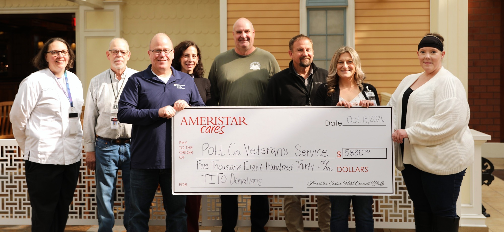 Ameristar leadership and VSO representatives with TITO donation check