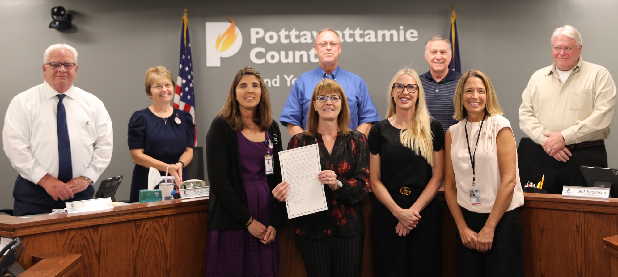 group posed with Elder Abuse Awareness Month proclamation with the Board of Supervisors