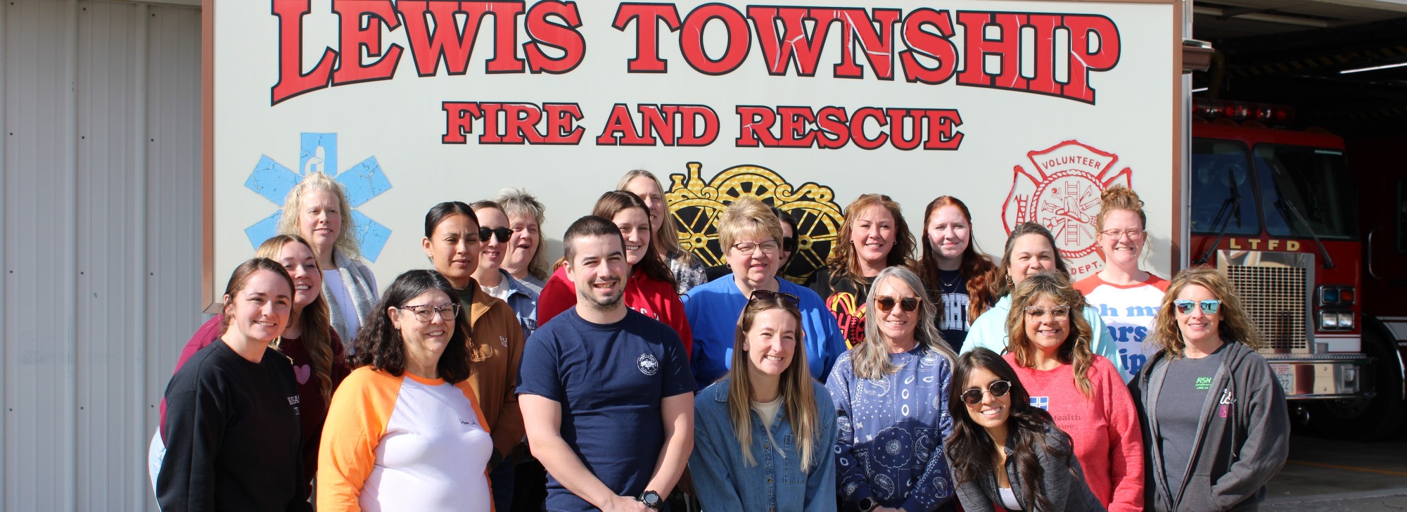 Public health and safety individuals after completing car seat safety training at Lewis Township Fire & Rescue