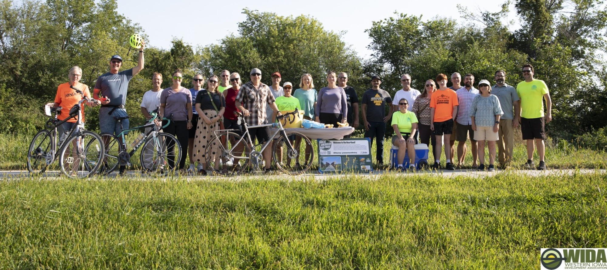 Group of individuals lined up on a trail with bikes