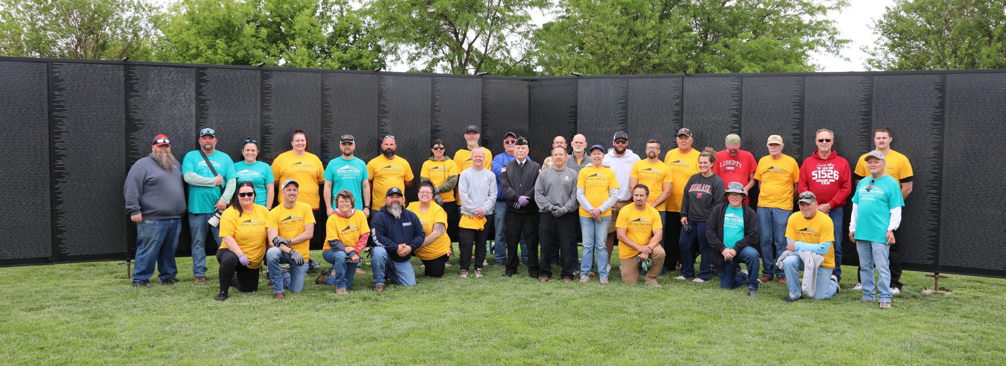 Volunteers in front of The Wall That Heals